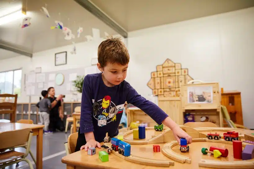 Children playing with toy trains at Choklits Child Care